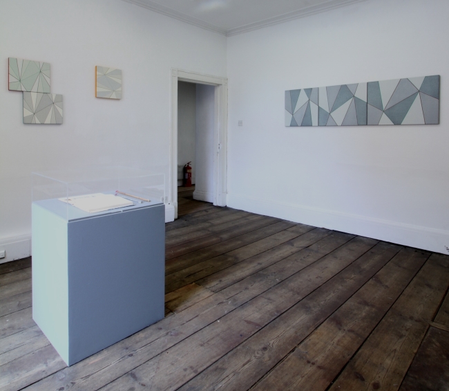 Installation shot showing Katrina Blannin paintings and plinth with Adam Gillam intervention with Anthony Hill pages from Module, Proportion, Symmetry. Image by courtesy of Andrew Bick 